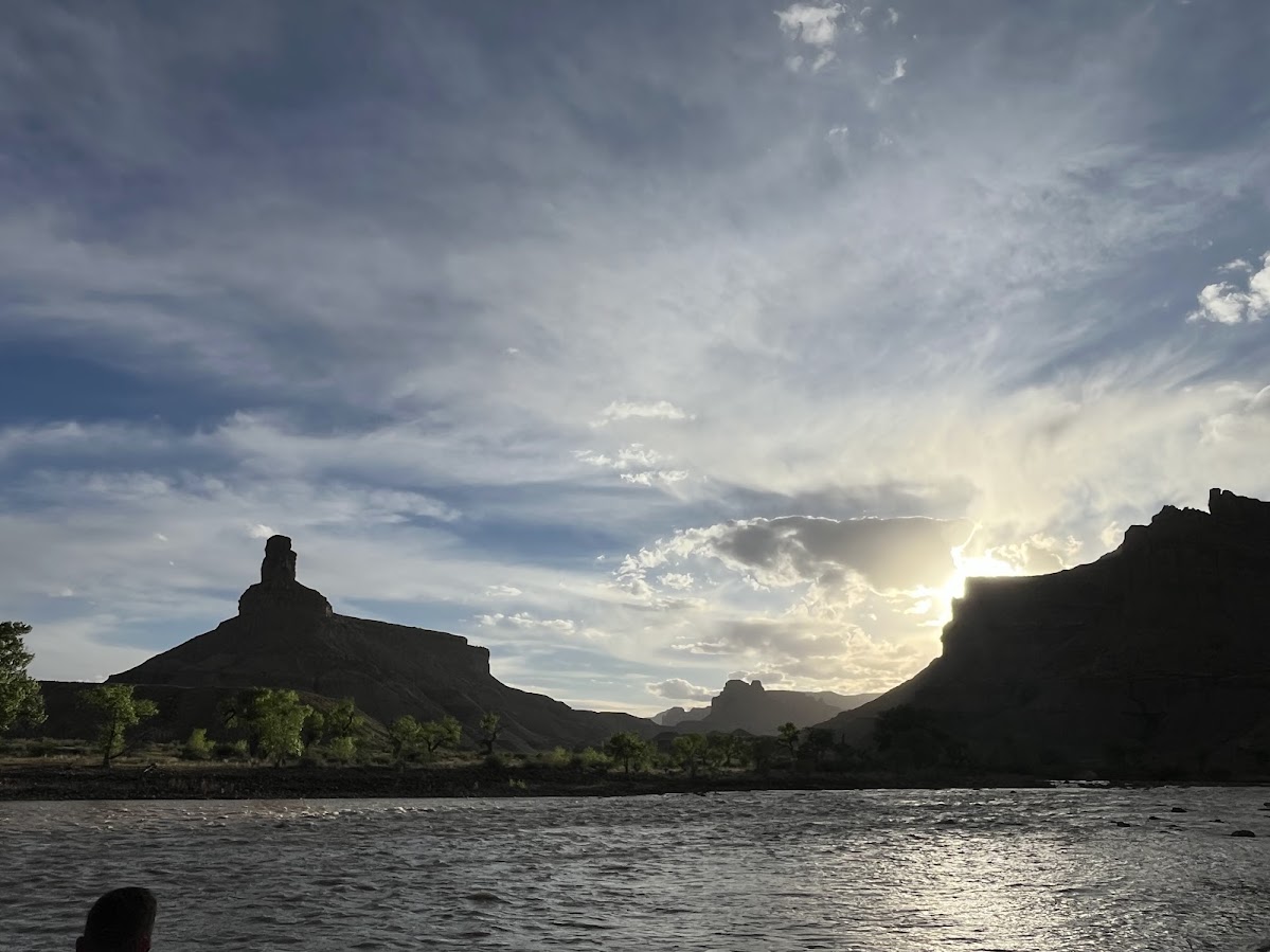 The Green River at dusk, a butte silhouetted against the sky in San Rafael country.